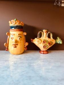 two vases sitting on top of a table at oPENhouse - loft - casa al mare in Pizzo