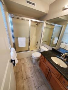 a bathroom with a toilet and a shower and a sink at Treehouse Condos - Branson in Branson