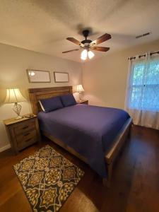 a bedroom with a bed and a ceiling fan at Treehouse Condos - Branson in Branson +18 photos