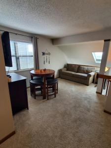 a living room with a table and a couch at Treehouse Condos - Branson in Branson