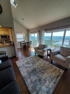 a living room with a couch and chairs and a table at Treehouse Condos - Branson in Branson