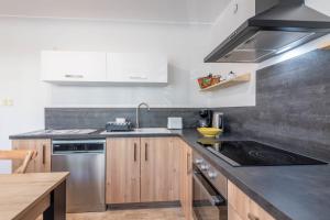 a kitchen with a sink and a stove at Ideally Located Furnished Townhouse With 3 Bedrooms Parking & Garden in Annecy