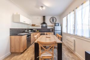 a kitchen with a table and chairs in a room at Ideally Located Furnished Townhouse With 3 Bedrooms Parking & Garden in Annecy