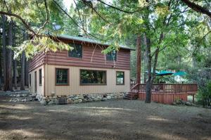 a small house in the middle of a forest at Bassett's Cabin in Wawona