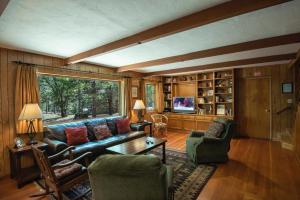 a living room with a couch and a table at Bassett's Cabin in Wawona