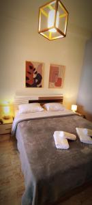 a bedroom with two beds with towels on them at CENTRAL ROYAL DREAM -Kiki in Volos