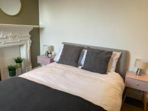 a bedroom with a large bed with two night stands at Walpole Bay Apartment in Cliftonville