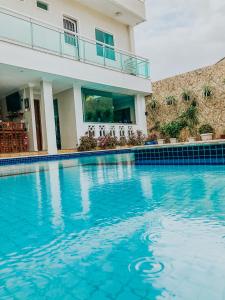 a swimming pool in front of a house at Hotel Antiga Roma in Belém