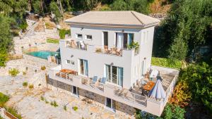 an aerial view of a house with a swimming pool at Villa Douros in Parga