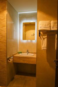 a bathroom with a sink and a mirror at Luciana Hotel by BRATUS in Aqaba