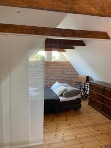 a bedroom with a bed and a brick wall at Apartmán U Březinů in Znojmo