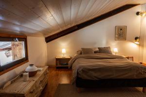 a bedroom with a large bed and a television at Grand chalet convivial avec sa piscine intérieure in Serraval +41 photos