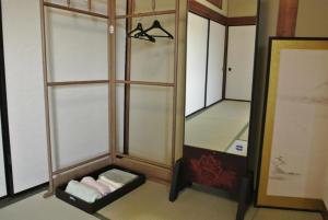 a dressing room with a mirror and a shelf at Minpaku Yorozuya - Vacation STAY 12905 in Kurayoshi