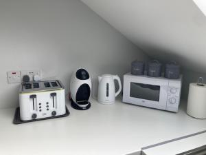 a kitchen counter with a microwave and appliances on it at Lir Lodge in Castlepollard