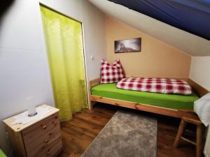 een kleine slaapkamer met een bed en een raam bij Ferienwohnung auf dem Fischer-Hof in Stolpen