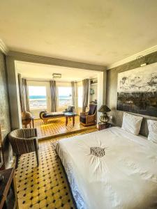 ein Schlafzimmer mit einem Bett und ein Wohnzimmer in der Unterkunft Vue Imprenable Le balcon de tanger in Tangier