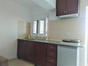 a kitchen with a sink and a counter top at Ahmeti Rooms in Ksamil
