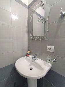 a bathroom with a white sink and a mirror at Ahmeti Rooms in Ksamil +62 photos