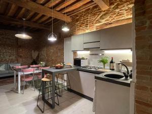 a kitchen with a counter and a table with bar stools at La casa dei Mimmi in Città della Pieve