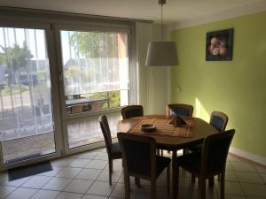 a dining room with a table and chairs and a window at Holiday home in Olsdorf in Bettingen