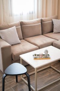 a living room with a couch and a table at LP Luxury Suite - Old Town Xanthi in Xanthi