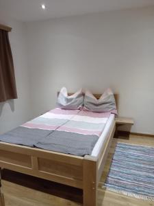 a bed sitting in a room with at MIKAS HAUS in Bad Aussee