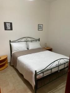 a bedroom with a bed and two signs on the wall at Casa Vacanze Linuccio in Casalabate