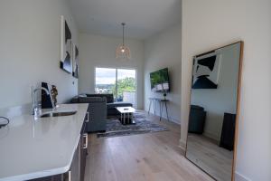 a living room with a kitchen and a living room with a couch at Downtown ATL Modern Home - Private Rooftop Terrace in Atlanta