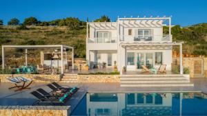 a villa with a swimming pool and a house at Avgi Villa in Agios Nikolaos