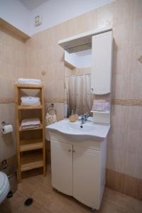 a bathroom with a white sink and a toilet at Sunset Resort in Aiándion