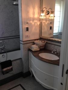 a bathroom with a sink and a mirror and a tub at SUNSET with view in Seborga in Seborga