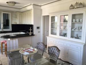 a kitchen with a glass table and chairs at SUNSET with view in Seborga in Seborga