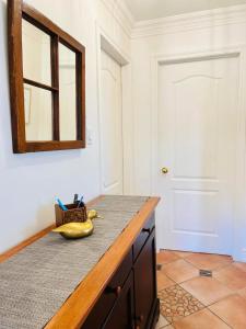 a bathroom with a counter with a mirror and a banana at Superbe condo plage-memphremagog in Magog-Orford