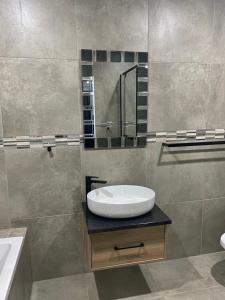 a bathroom with a sink and a mirror at The One Kathu in Kathu