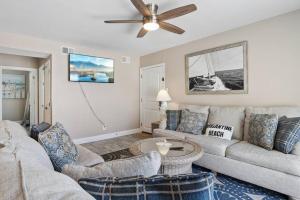 a living room with a couch and a ceiling fan at Beach Block Parking Deck in Brigantine
