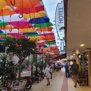 a group of colorful umbrellas hanging over a street at Hotel Gumz in Balneário Camboriú