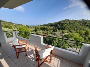 a balcony with chairs and a view of a mountain at View house, Platana Kymi Evoia in Platána