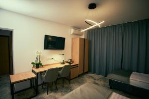 Pokój hotelowy z biurkiem, łóżkiem i pokojem w obiekcie Acodomo Apartamenty w mieście Poddębice