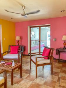 a room with two chairs and a bed and a table at Art 57 Hotel - Adults Only in Mérida