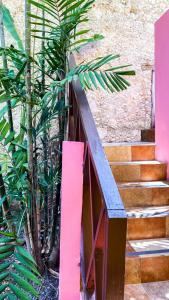 a set of stairs with a pink railing and a plant at Art 57 Hotel - Adults Only in Mérida