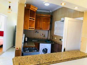 a kitchen with a refrigerator and a stove top oven at Maamoura Beach apartment in Alexandria