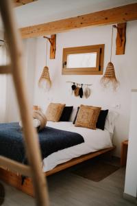 a bedroom with a bed with white sheets and pillows at Eco Finca Sa Becadeta in Llucmajor