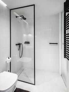 a white bathroom with a shower and a toilet at Acropol Studio Loft with amazing view & terrace in Athens