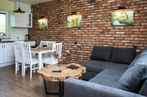 a living room with a couch and a brick wall at Domki Nordic in Władysławowo
