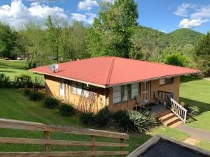 a small house with an orange roof at Phillips Historic Motel & Cottages in Robbinsville