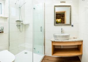 a bathroom with a sink and a shower at Domki Nordic in Władysławowo