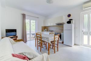 a living room with a couch and a table with chairs at Dora Apartment-Adults Only in Senj