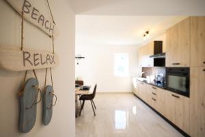 a room with a kitchen and a dining room at Holiday house Antulov in Vodice