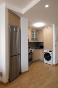 a kitchen with a stainless steel refrigerator and a dishwasher at Malpica Vistas in Malpica
