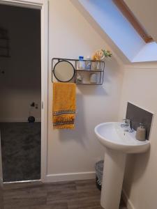 a bathroom with a sink and a window at Spacious Ensuite King Room Private Neighbourhood Free Parking Space in Oldham
